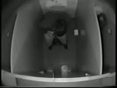 In the bathroom, one dark-brown mother makes water and wipes her cunny.